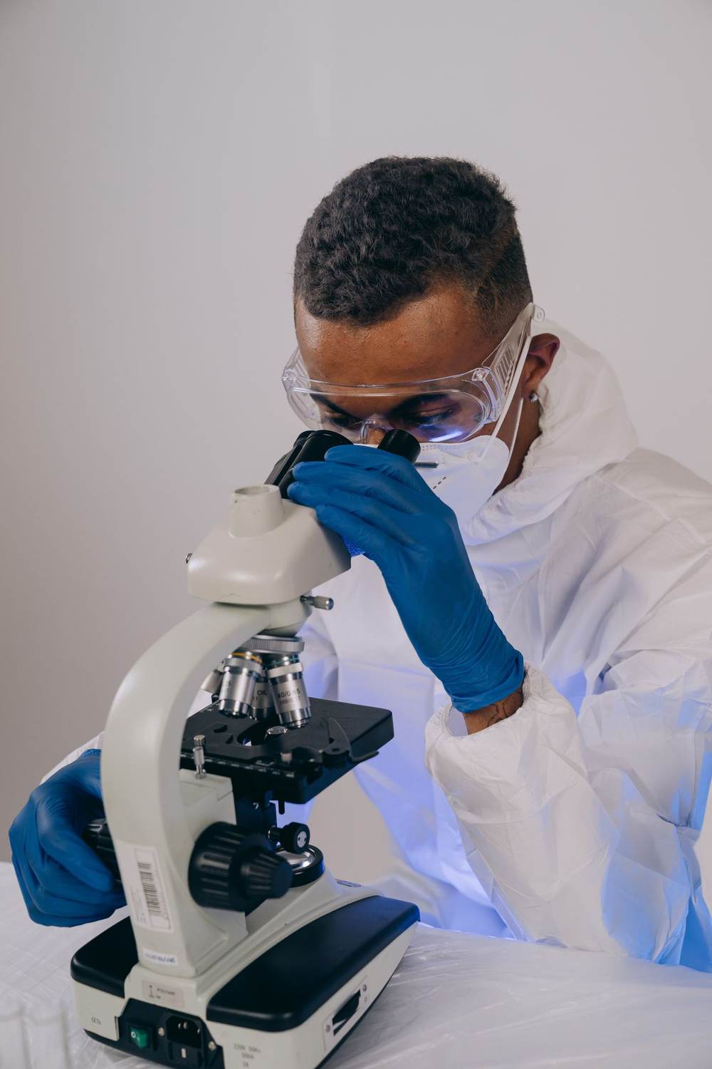 Researcher examining a sample under a microscope